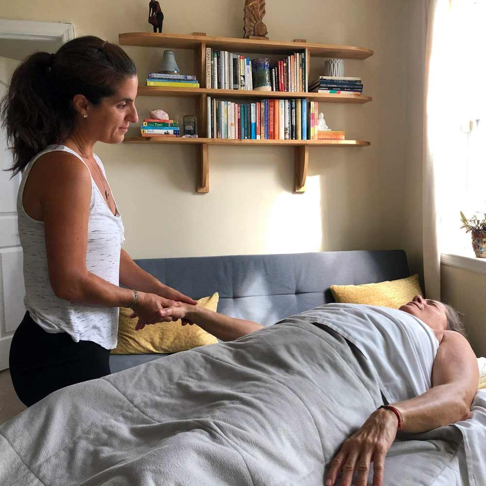 Dana working with massage client in their homel.